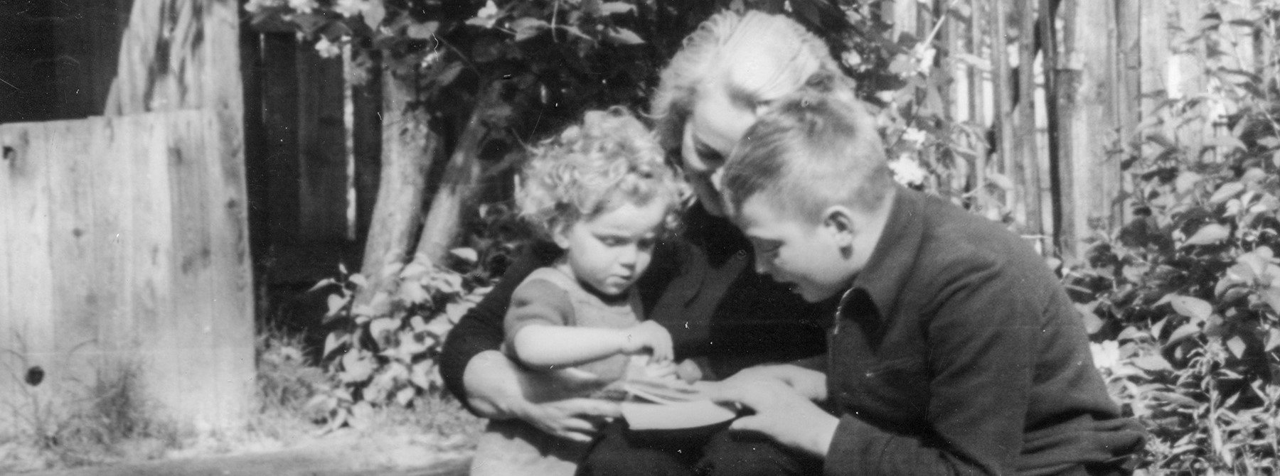 Black and white photo of mother reading with children