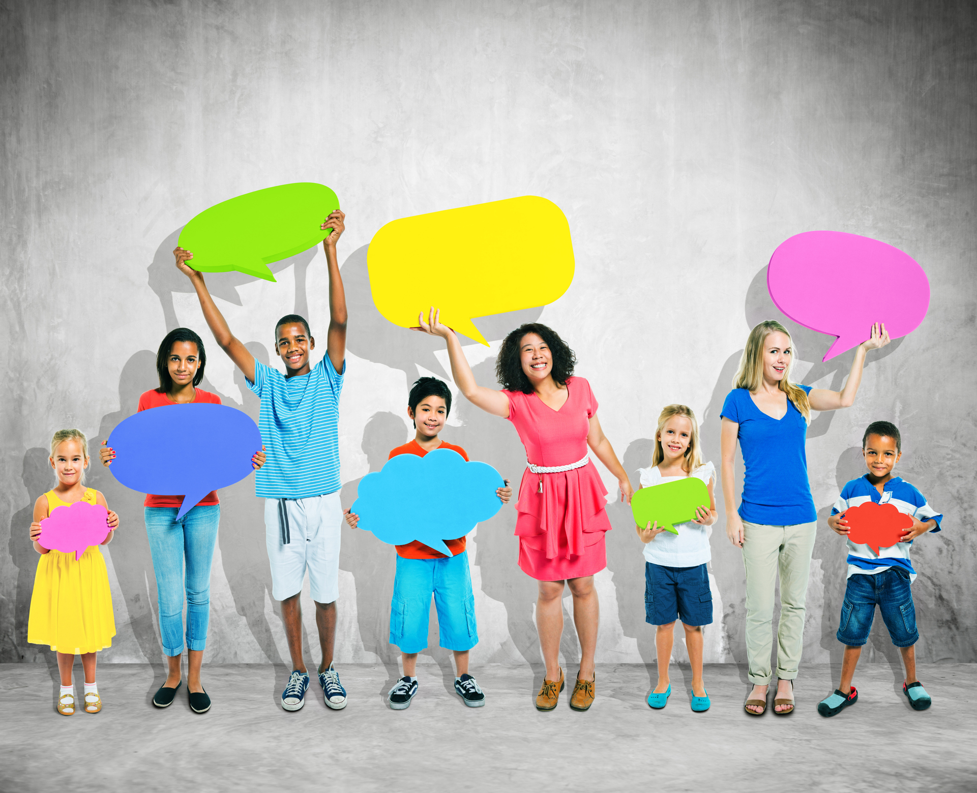 Kids and teens holding colourful speech bubbles