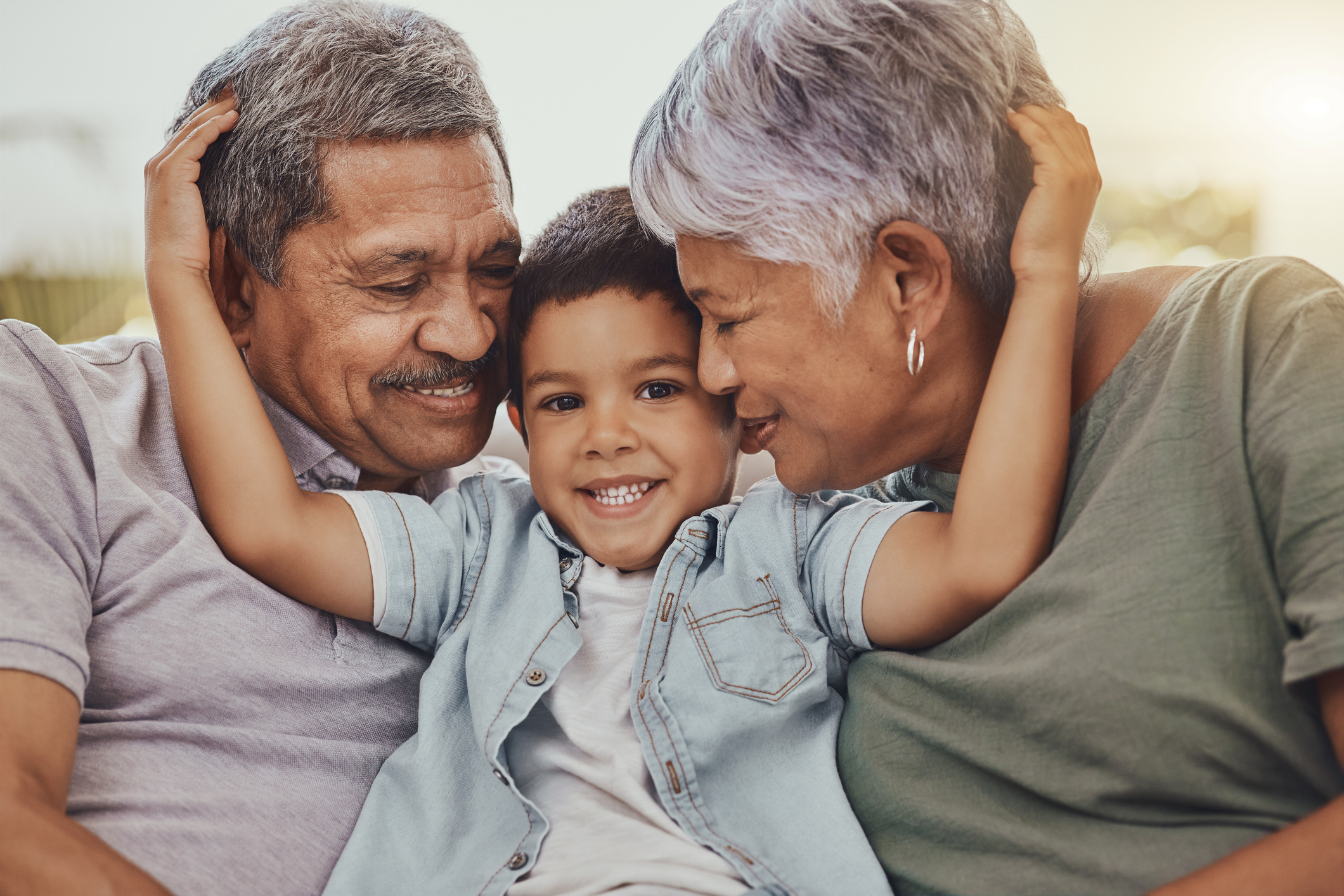 Boy embracing grandparents